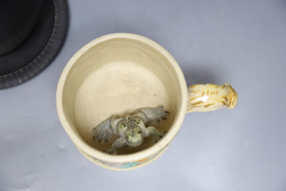 A 19th century Staffordshire pottery model of a zebra, a Victorian relief-moulded frog mug, a black basalt coffee pot with cover on sta